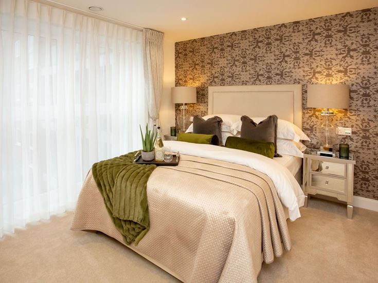 a hotel room with a bed and lamps