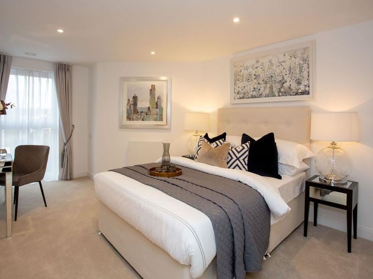 a bedroom with a bed and lamps