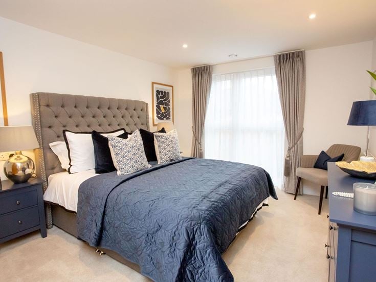 a bedroom with a bed and a chair