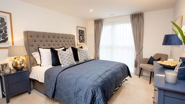 a bedroom with a bed and a chair