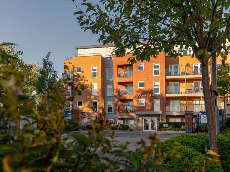 a building with trees in front