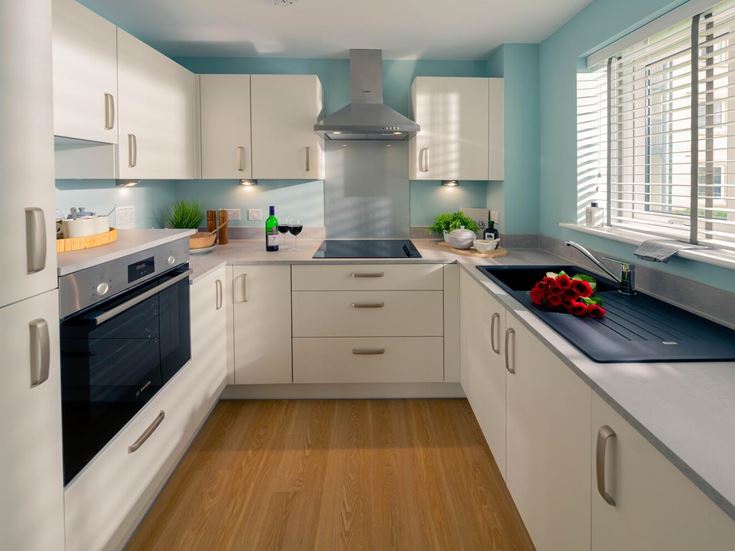 a kitchen with white cabinets