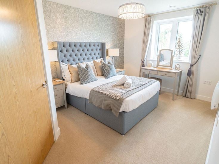 a bedroom with a bed and a desk