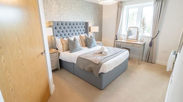 a bedroom with a bed and a desk
