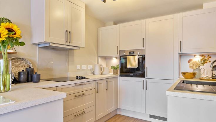 a kitchen with white cabinets
