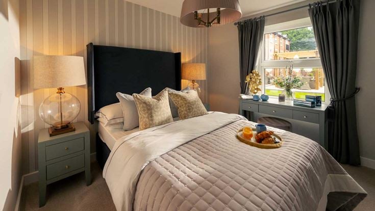 a bed with a tray of food