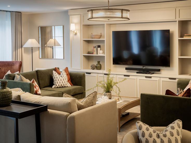 a living room with a tv and couches