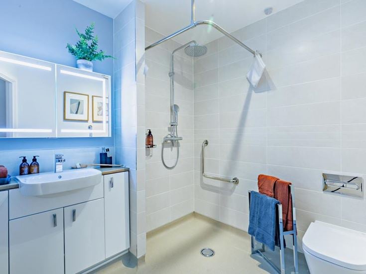 a bathroom with a shower unit and sink