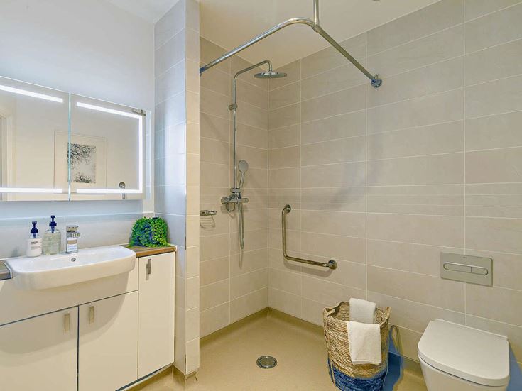 a bathroom with a shower unit and toilet