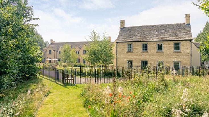 a fenced in yard with a house in the background