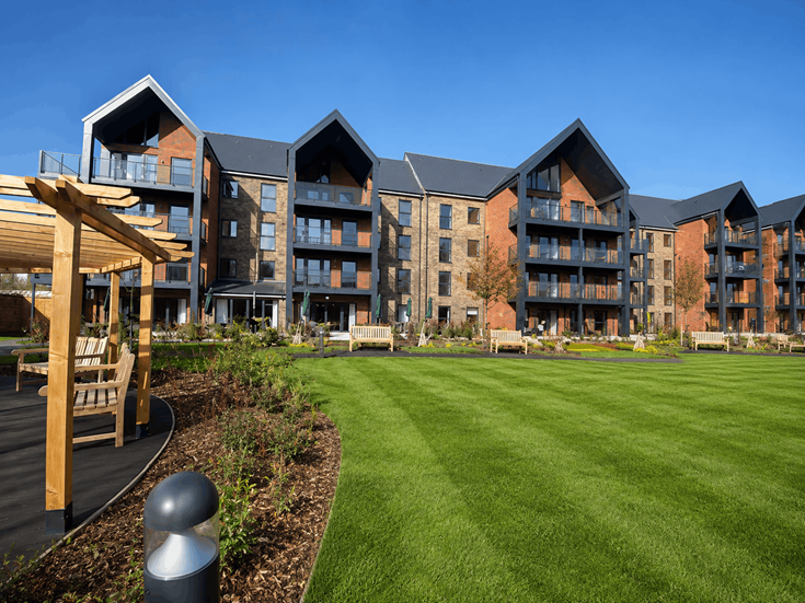 a building with a lawn and a fence in front of it