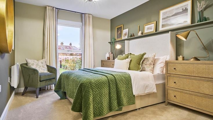 a bedroom with a bed and a chair
