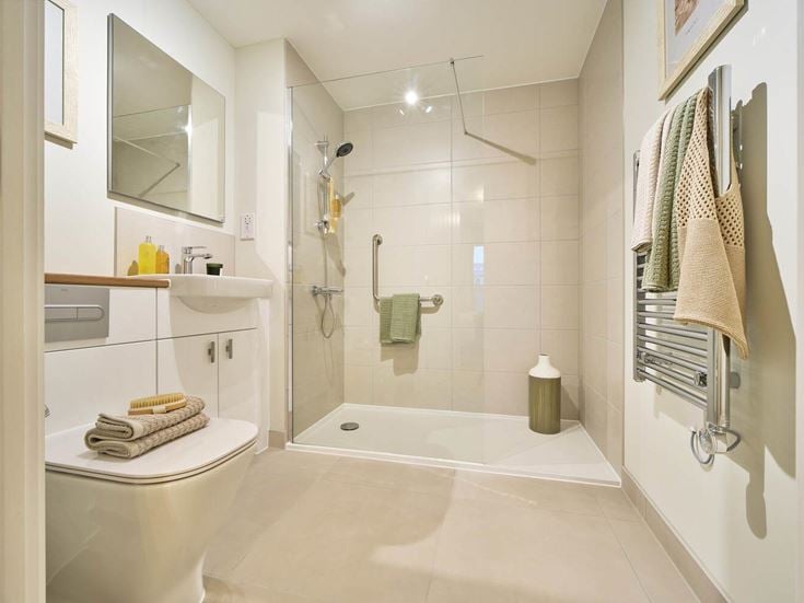 a bathroom with a tub sink and towels