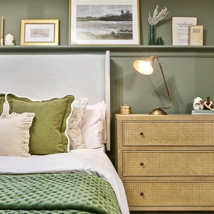 a bed with green pillows