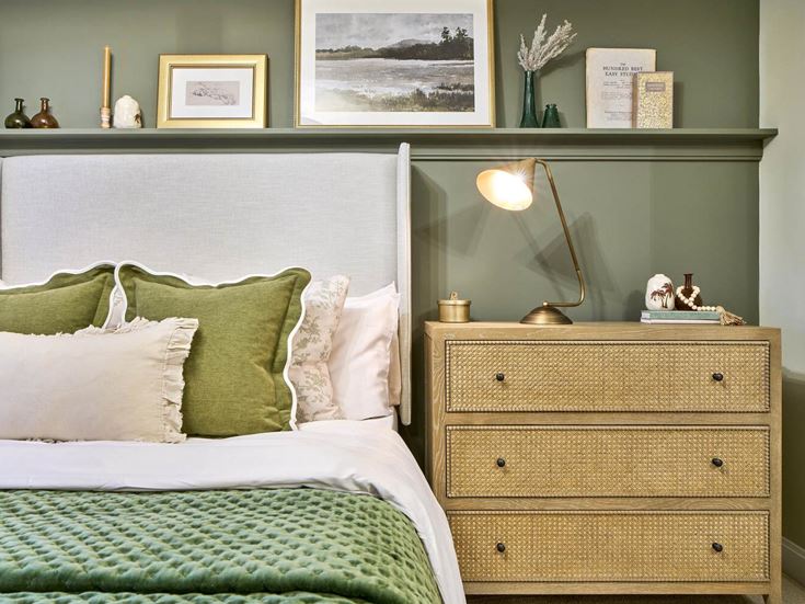 a bed with green pillows
