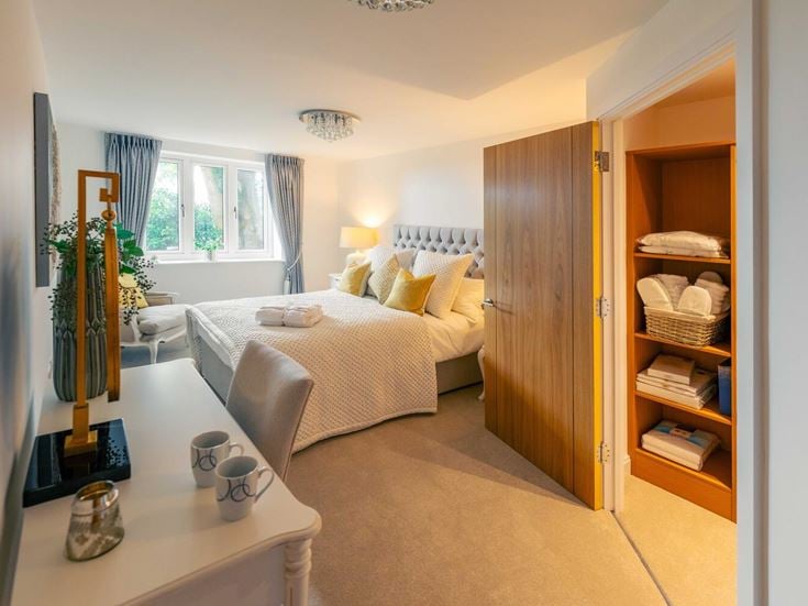 a bedroom with a bed and a table