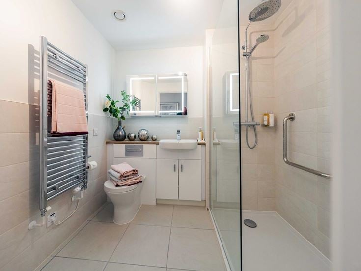 a bathroom with a shower unit and toilet