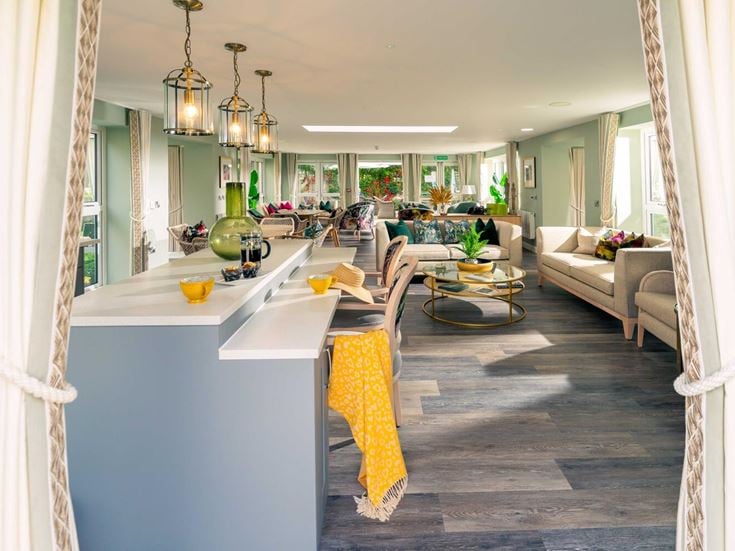 a large room with a bar and chairs