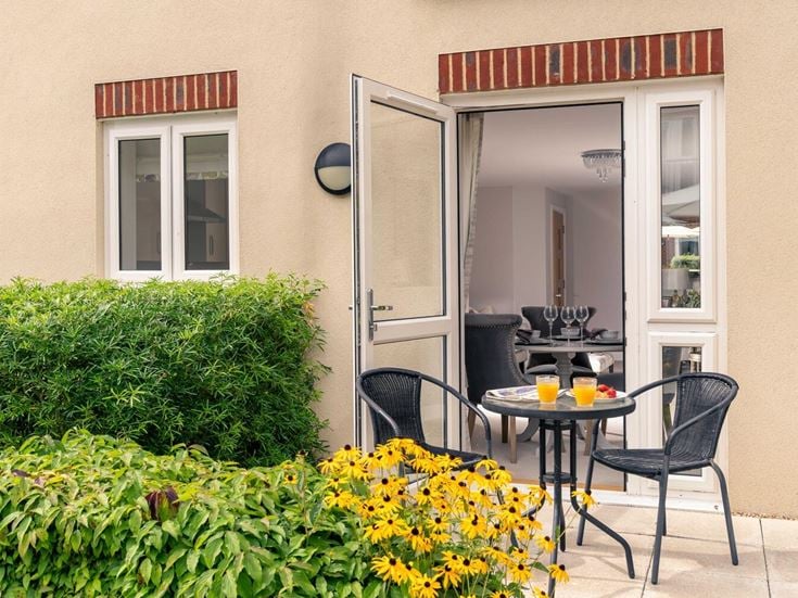 a table and chairs outside a house