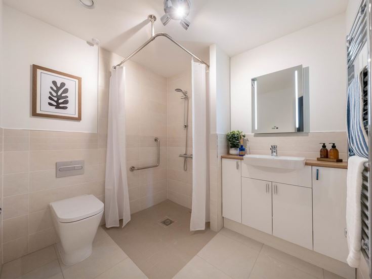 a bathroom with a shower unit and toilet