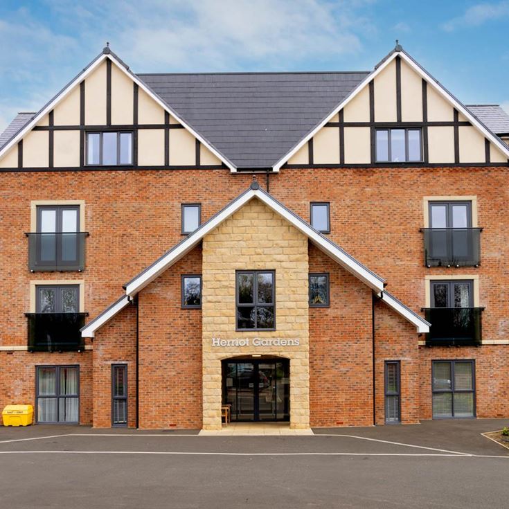 a brick building with a parking lot