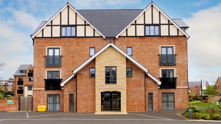 a brick building with a parking lot