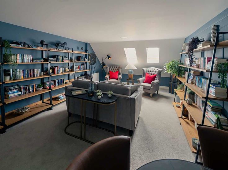 a living room with a book shelf and a coffee table