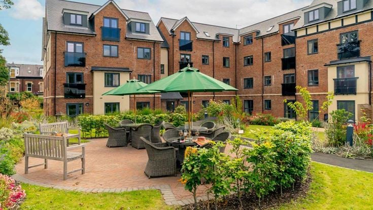 a courtyard with tables and chairs