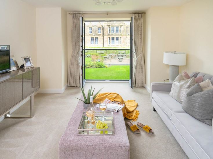 a living room with a tv and couches