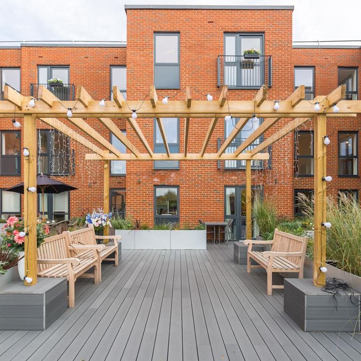 a brick building with tables and chairs outside
