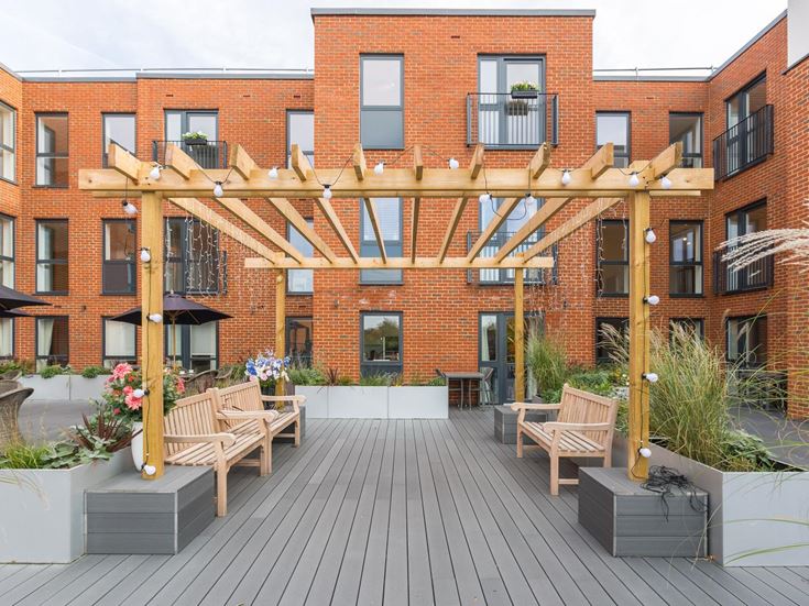 a brick building with tables and chairs outside