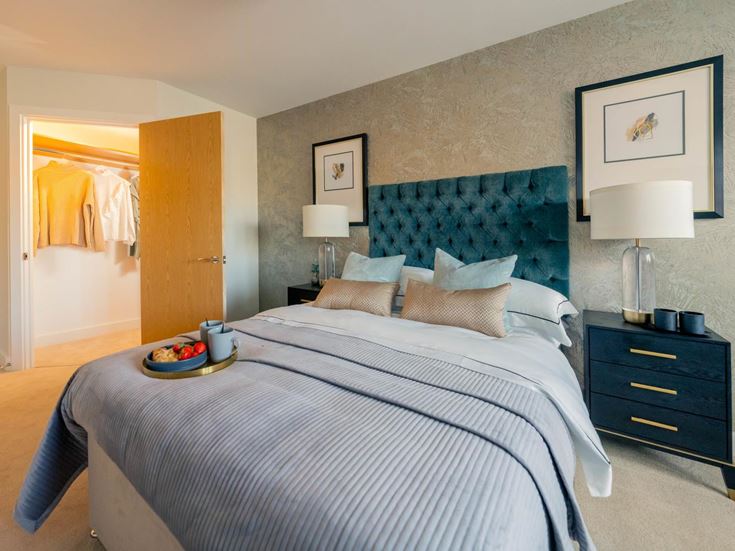a bedroom with a bed and lamps