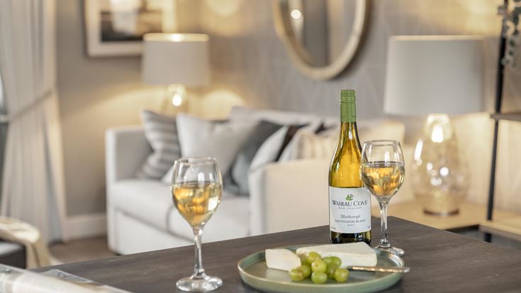 a table with wine glasses and a bottle of wine