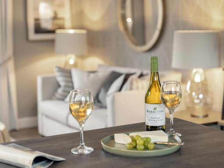 a table with wine glasses and a bottle of wine