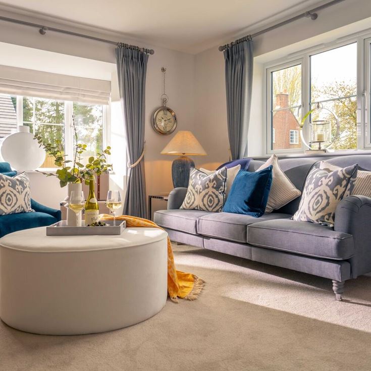 a living room with a couch and chairs