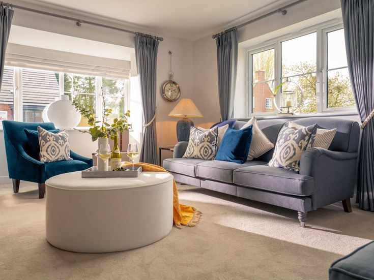 a living room with a couch and chairs