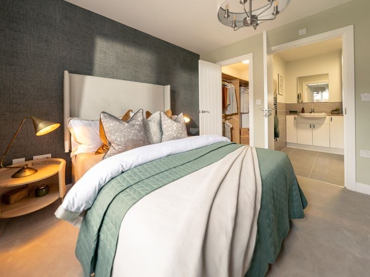 a bedroom with a bed and a desk