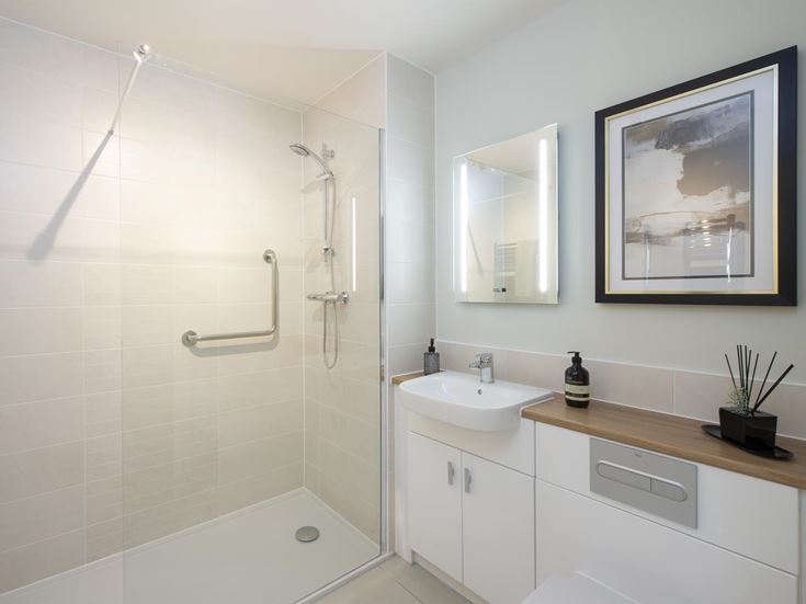 a bathroom with a sink and a shower unit