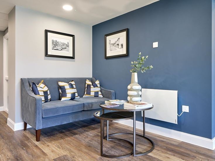 a living room with a blue wall