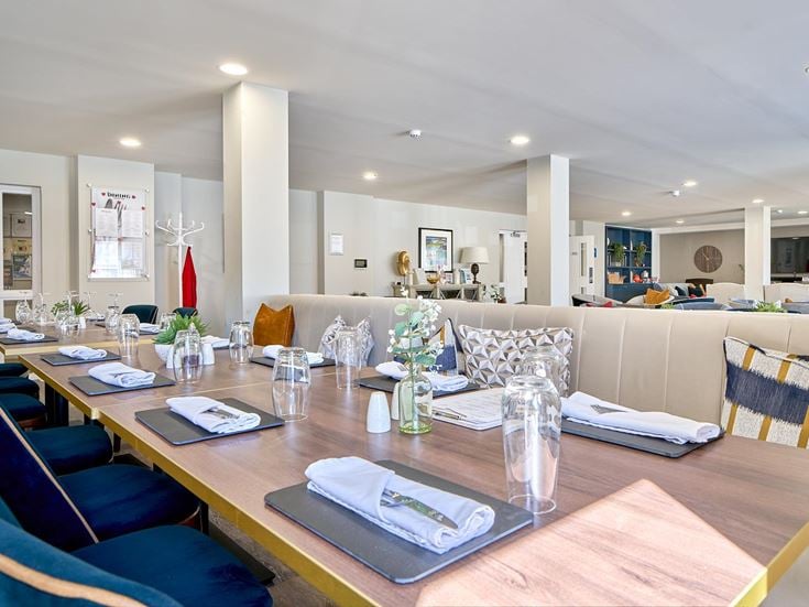 a large dining room with blue chairs