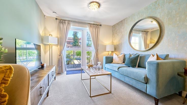 a living room with a blue couch and a round mirror