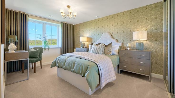 a bedroom with a bed and a desk