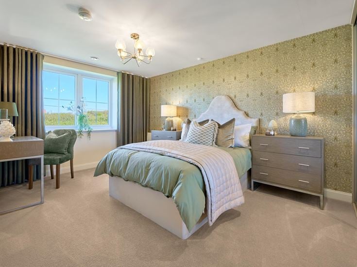 a bedroom with a bed and a desk