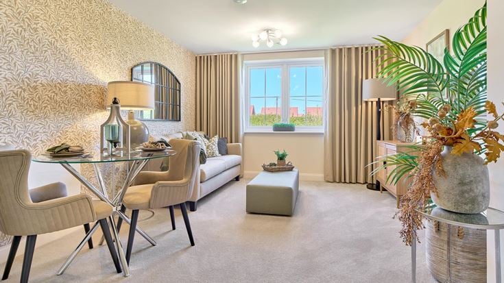a living room with a table and chairs