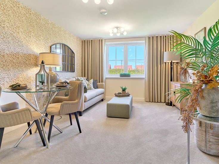 a living room with a table and chairs