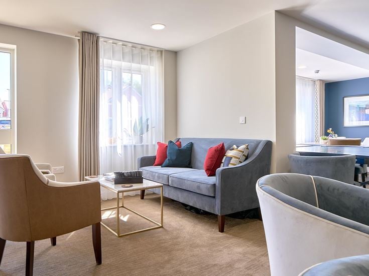 a living room with a couch and chairs