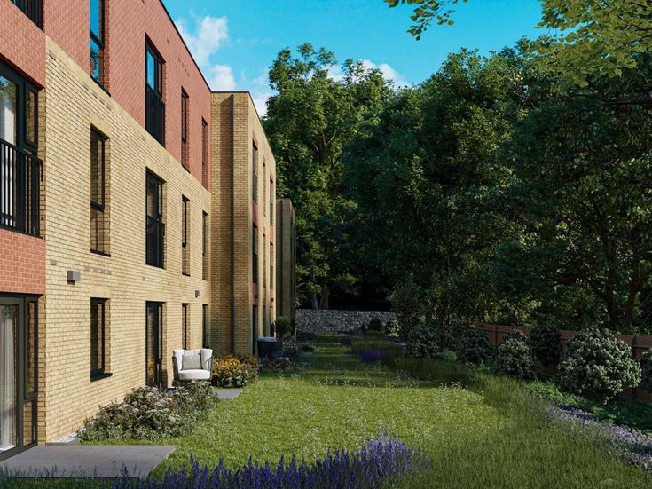 a brick building with a garden in front of it