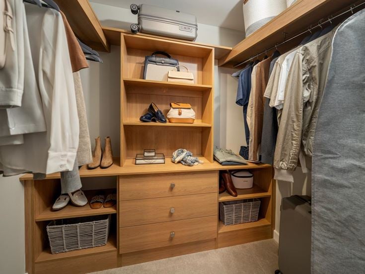 a closet with clothes and shoes