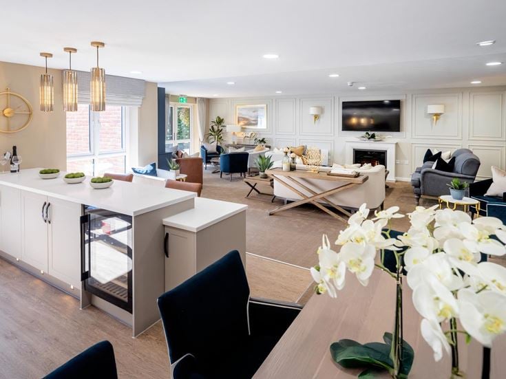 a large living room with a large white table and chairs