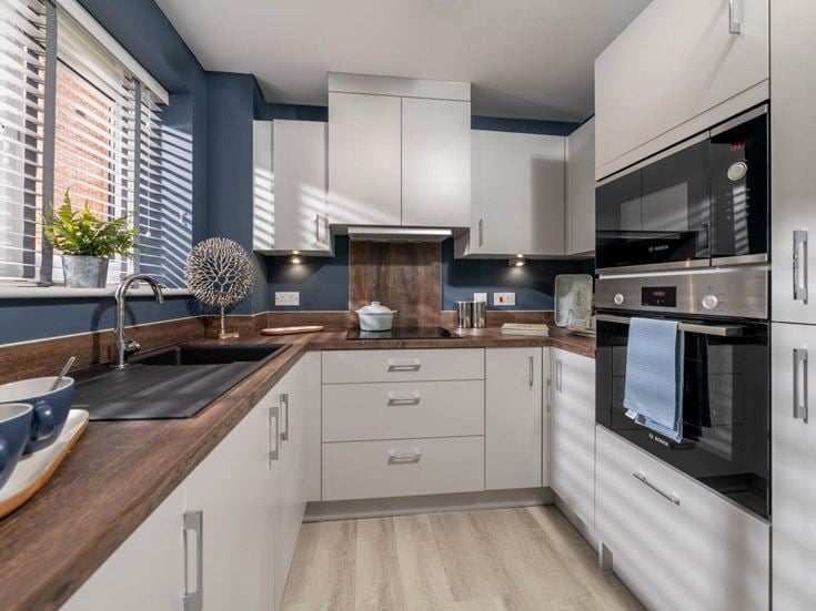 a kitchen with white cabinets